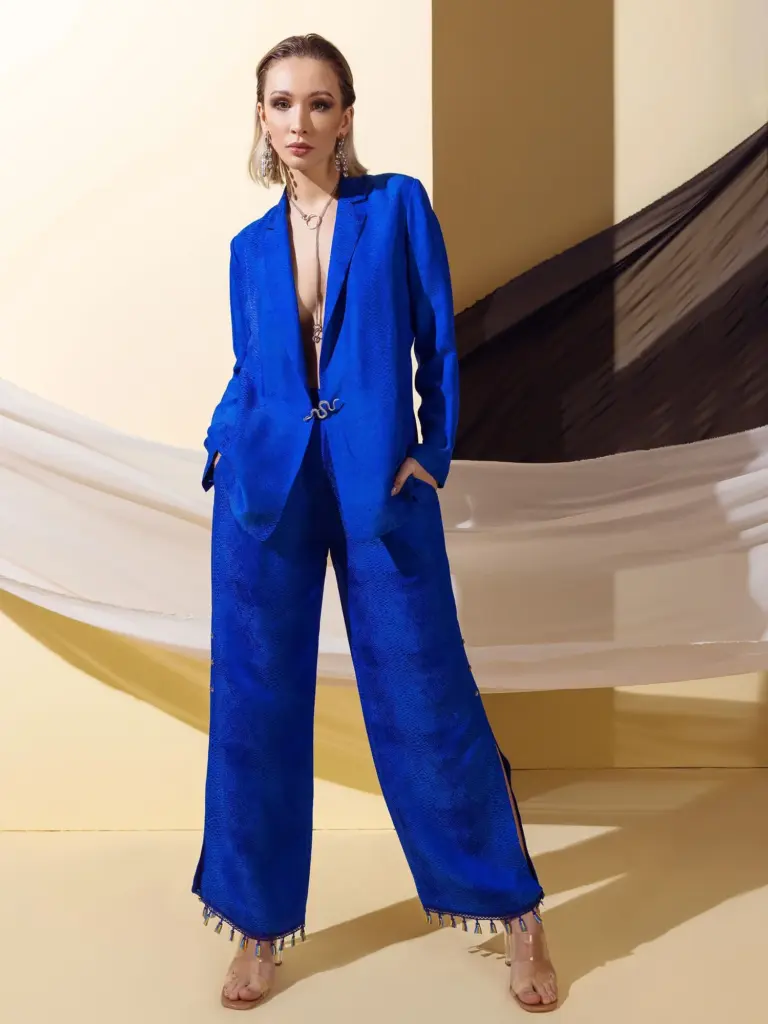 A model posing in a premium deep blue suit made from Viscose Jacquard fabric, showcasing the intricate woven texture and Passionworks' expert tailoring.