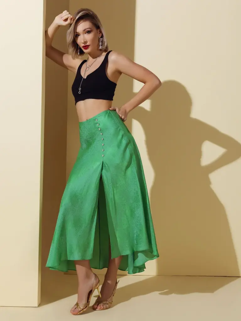 Close-up of emerald green natural silk skirt showing a soft drape and luxurious shape, used for premium jacket and pant production.