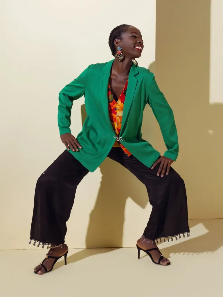 Emerald green silk tailored jacket with pink striped trim, showcasing Passionworks' high-end garment construction and pattern matching.